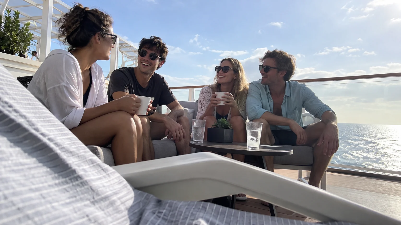 Young adult friends relax together on a contemporary cruise sun deck.