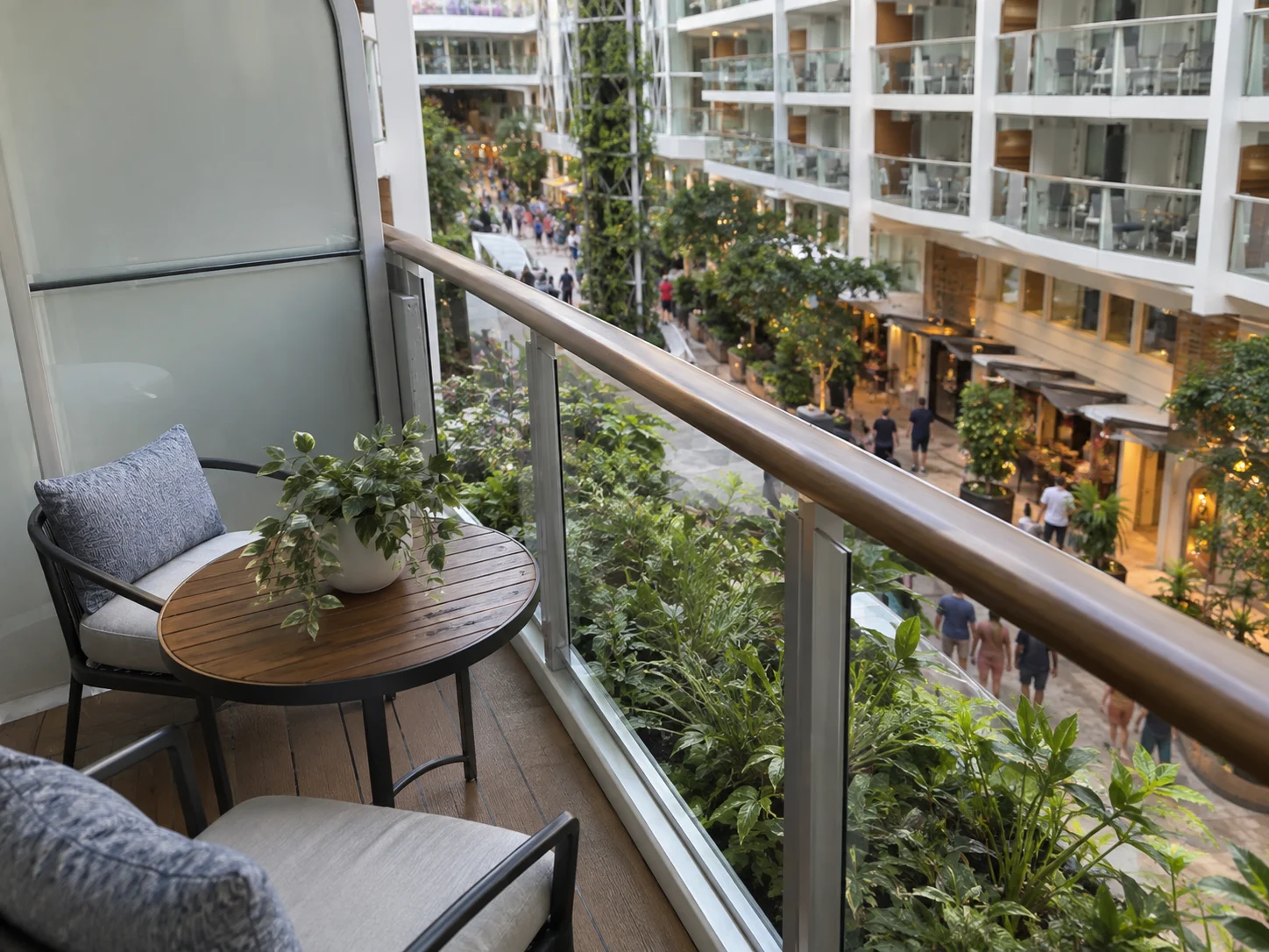Cruise balcony facing an interior neighborhood promenade and other balconies.