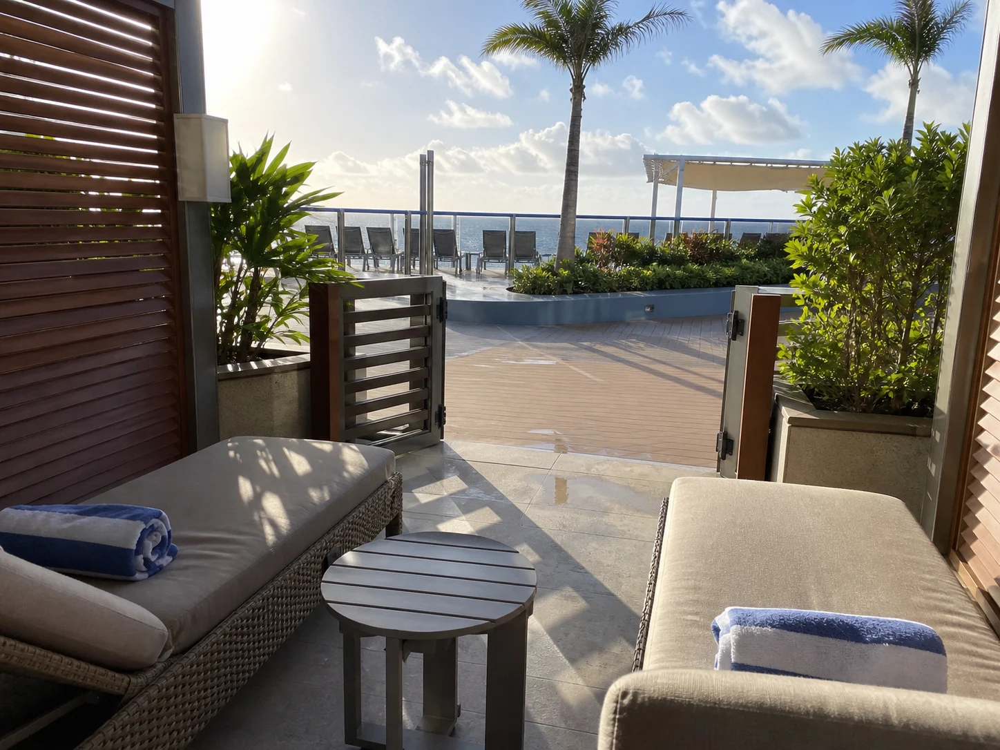 Cabana-style cruise patio opening through a low gate to a shared public deck.