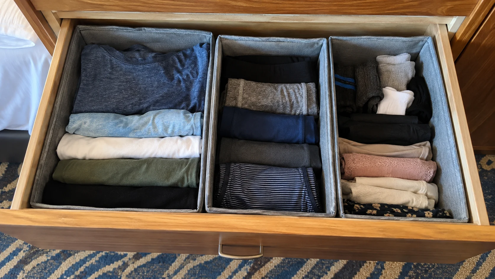 Open cruise cabin drawer organized with packing cubes used as removable drawers