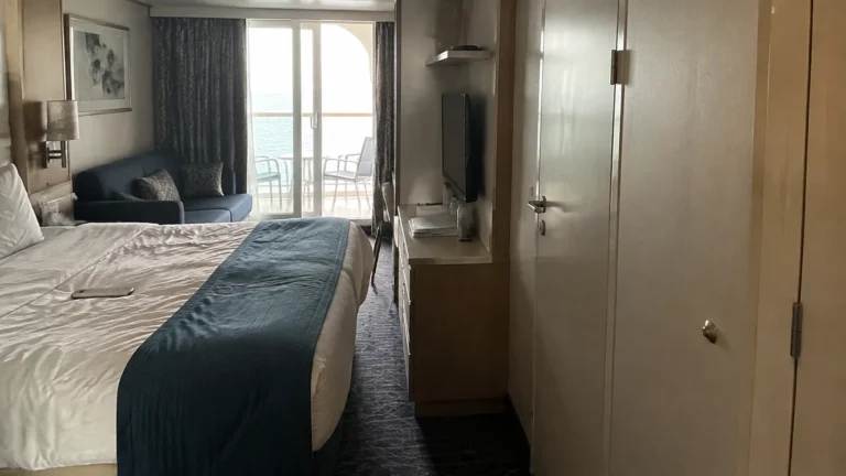 Cruise cabin with a double bed and sliding balcony doors