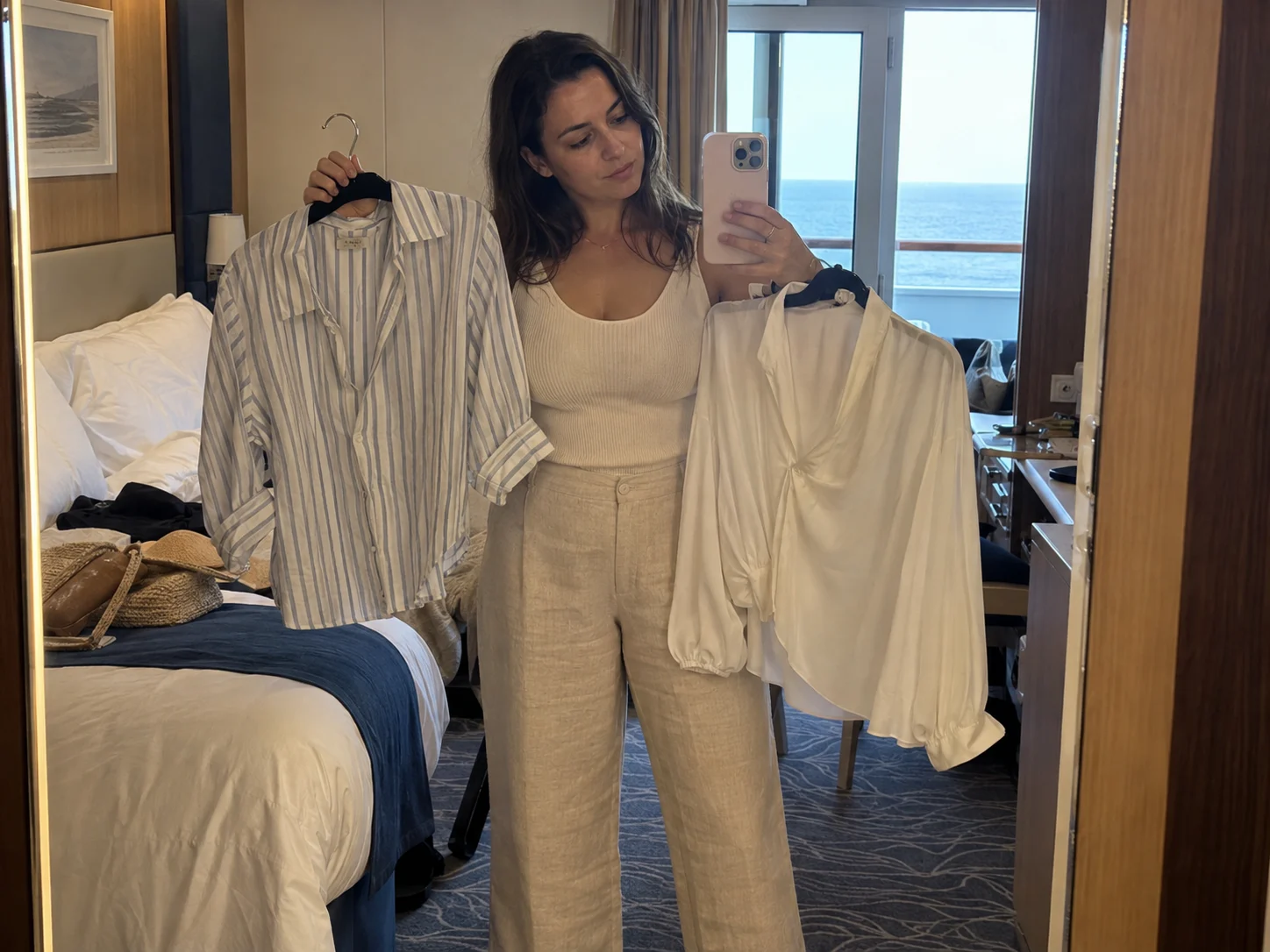 A traveler compares two tops that work with the same neutral trousers.