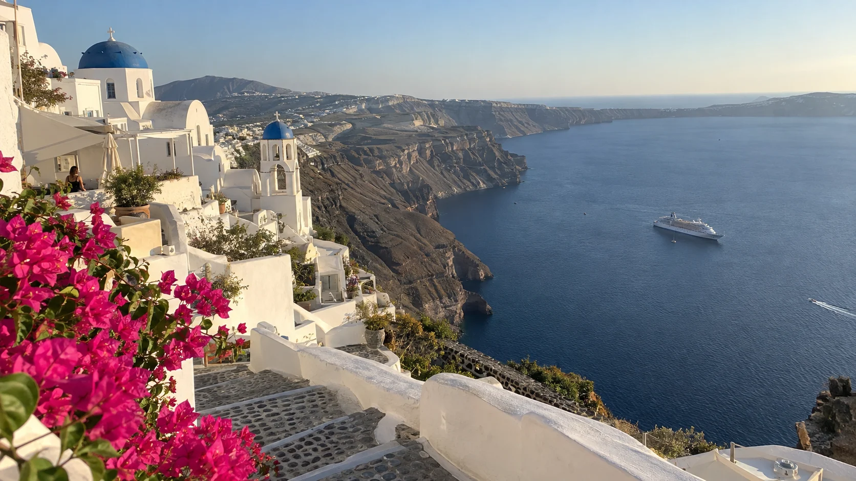 Whitewashed Santorini village overlooking a cruise ship in the Aegean Sea