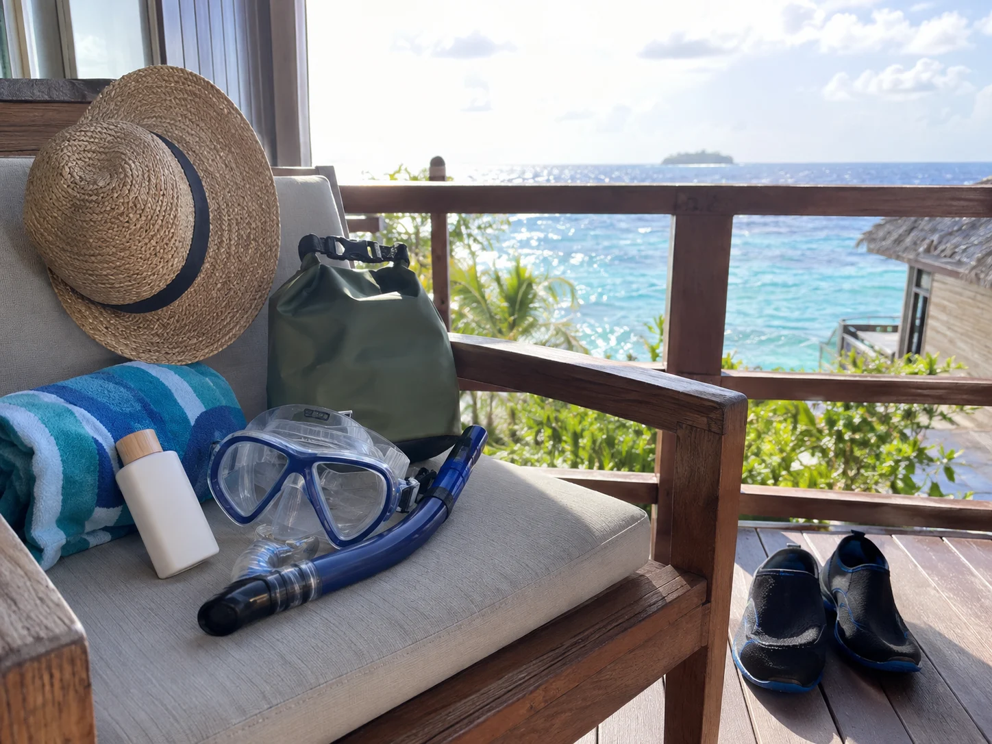 Snorkel mask, reef-safe sunscreen, water shoes, dry bag, and towel packed for a beach excursion