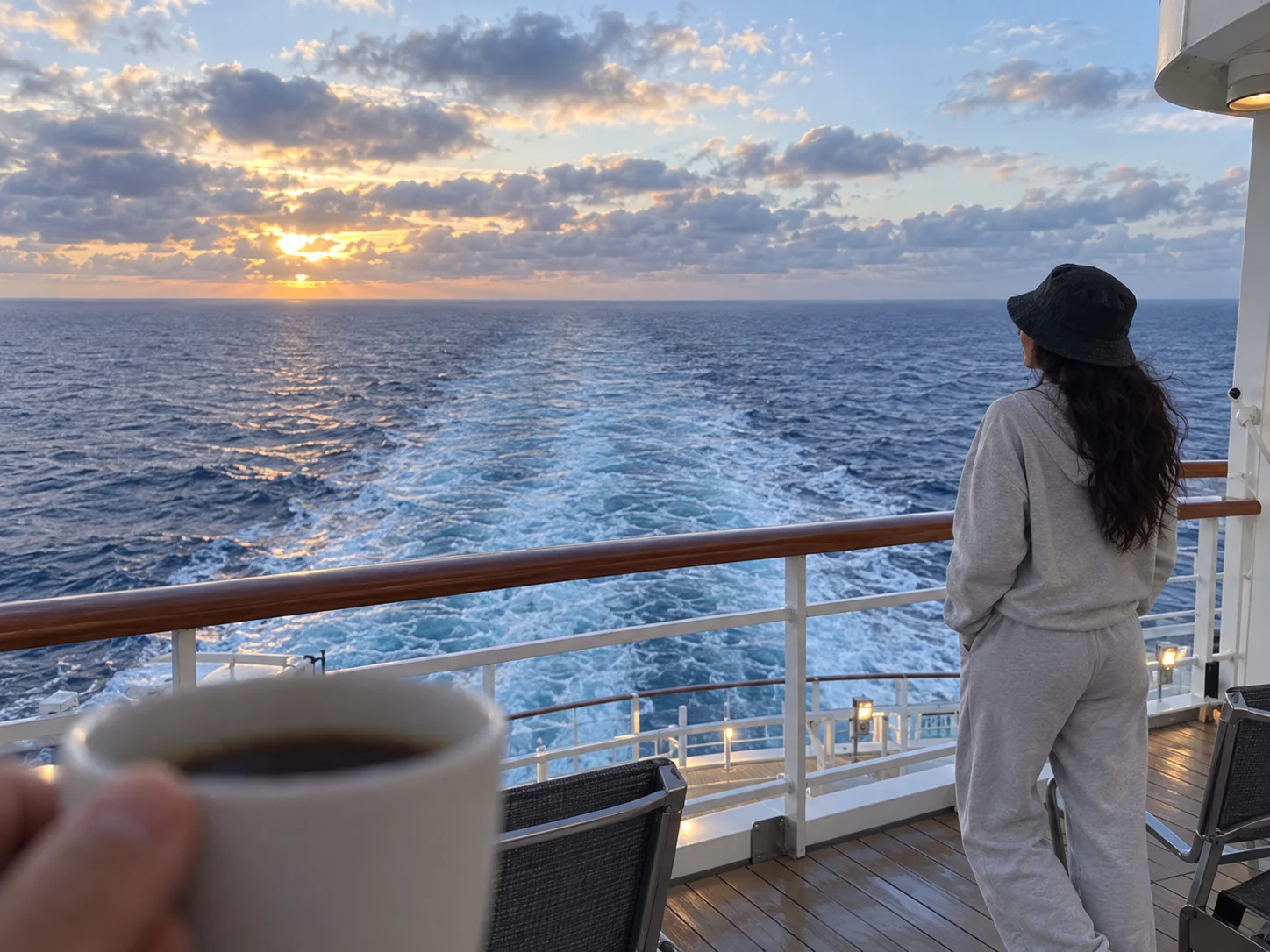 Ellie stands at the stern as the ship's wake leads toward the horizon.