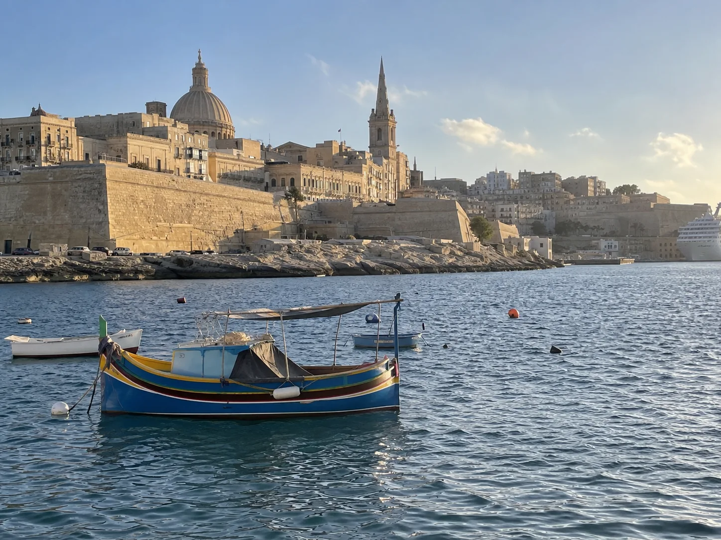 Valletta's limestone fortifications rise above the blue water of Grand Harbour.