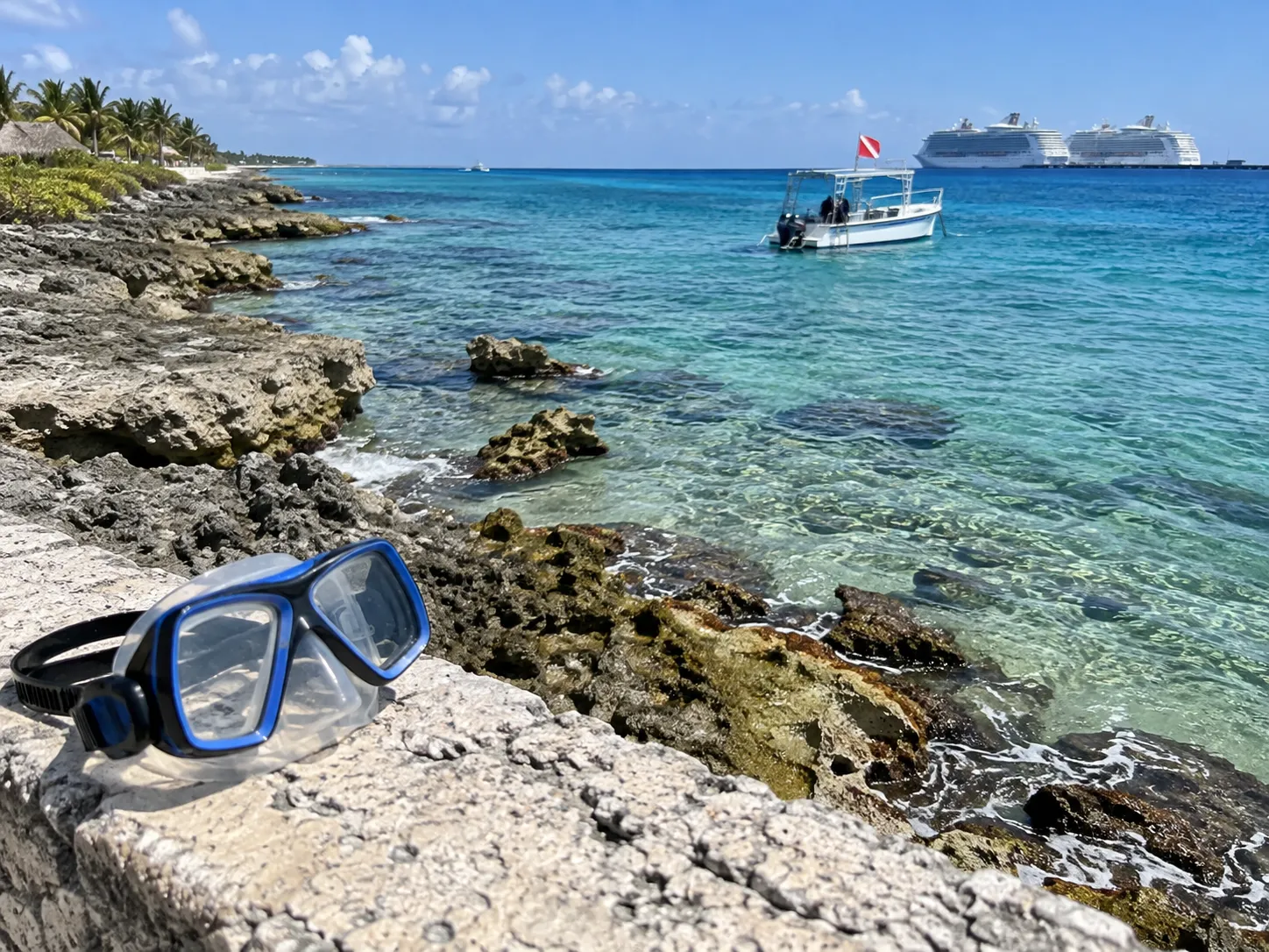 Transparent Caribbean water meets Cozumel's rocky shoreline near the cruise port.