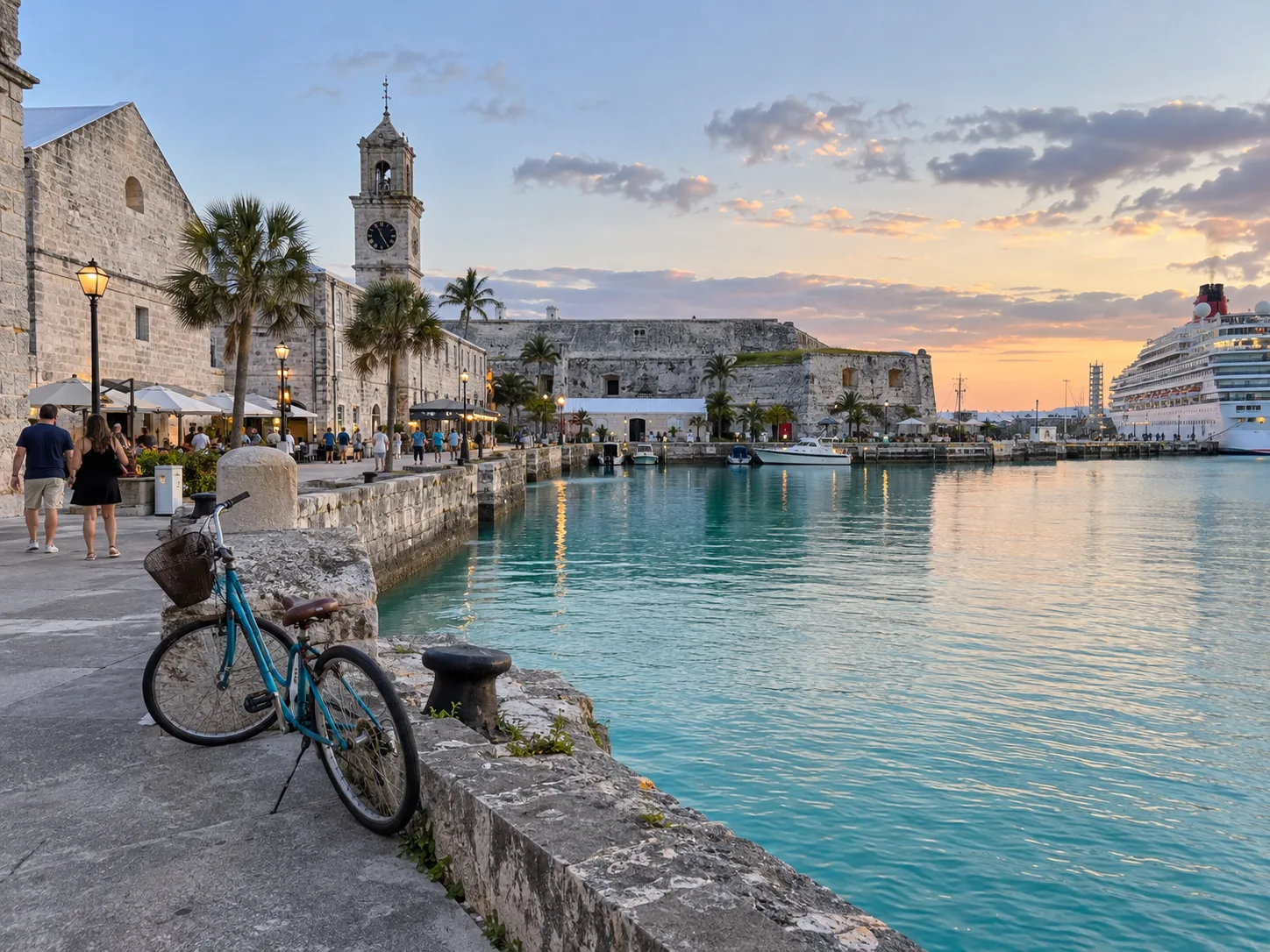 Historic stone buildings and calm turquoise water fill Bermuda's Royal Naval Dockyard.
