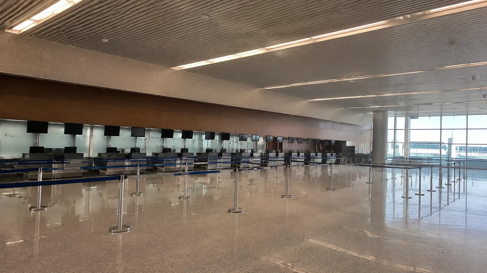 Empty terminal queue lanes lead toward a row of counters.
