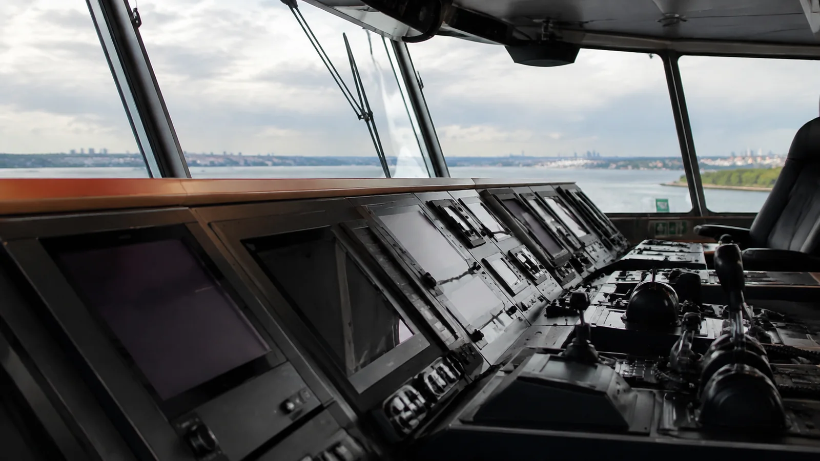 Navigation screens and controls across a modern ship's bridge.