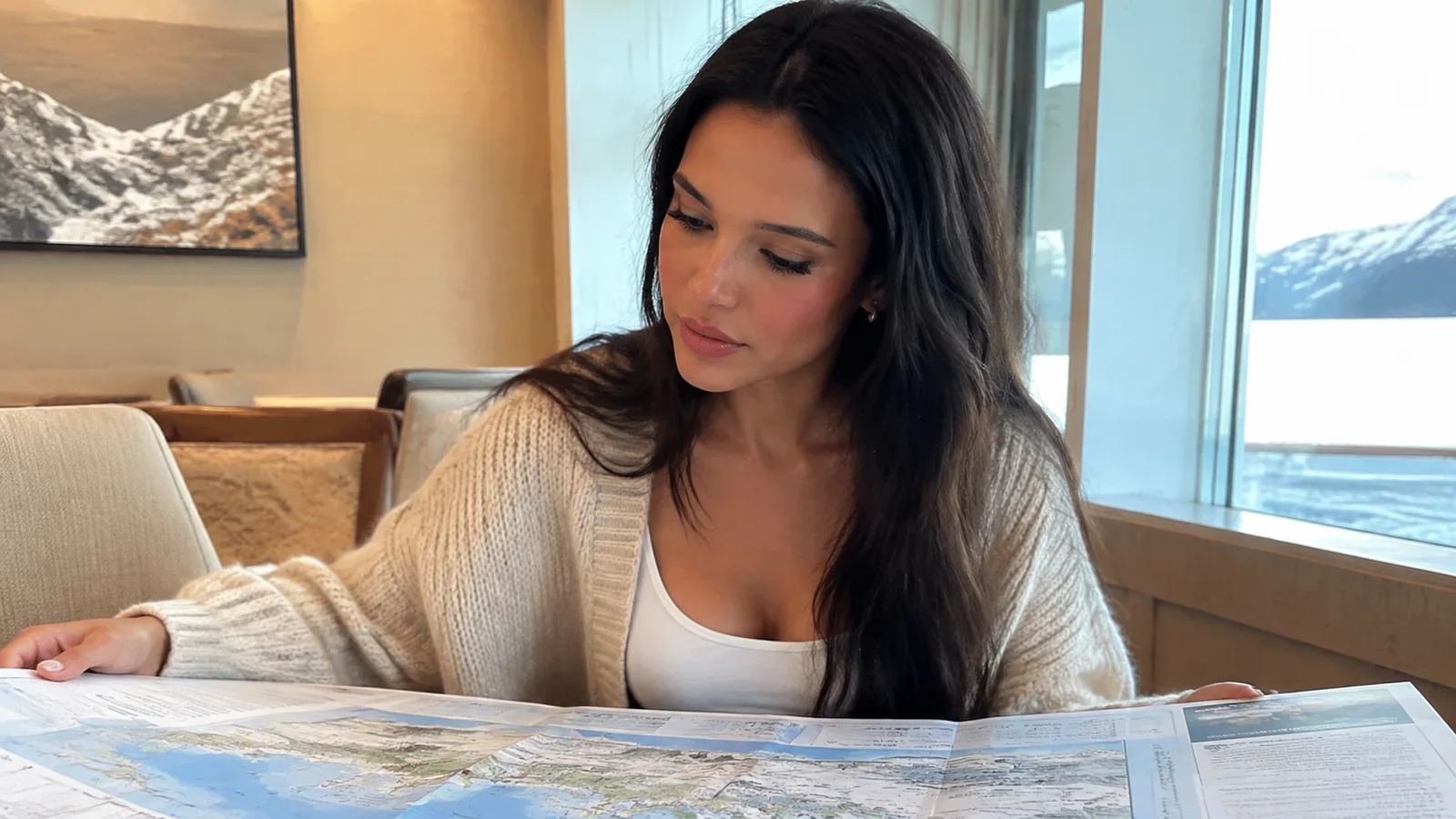 Woman studying a large map beside a ship window.