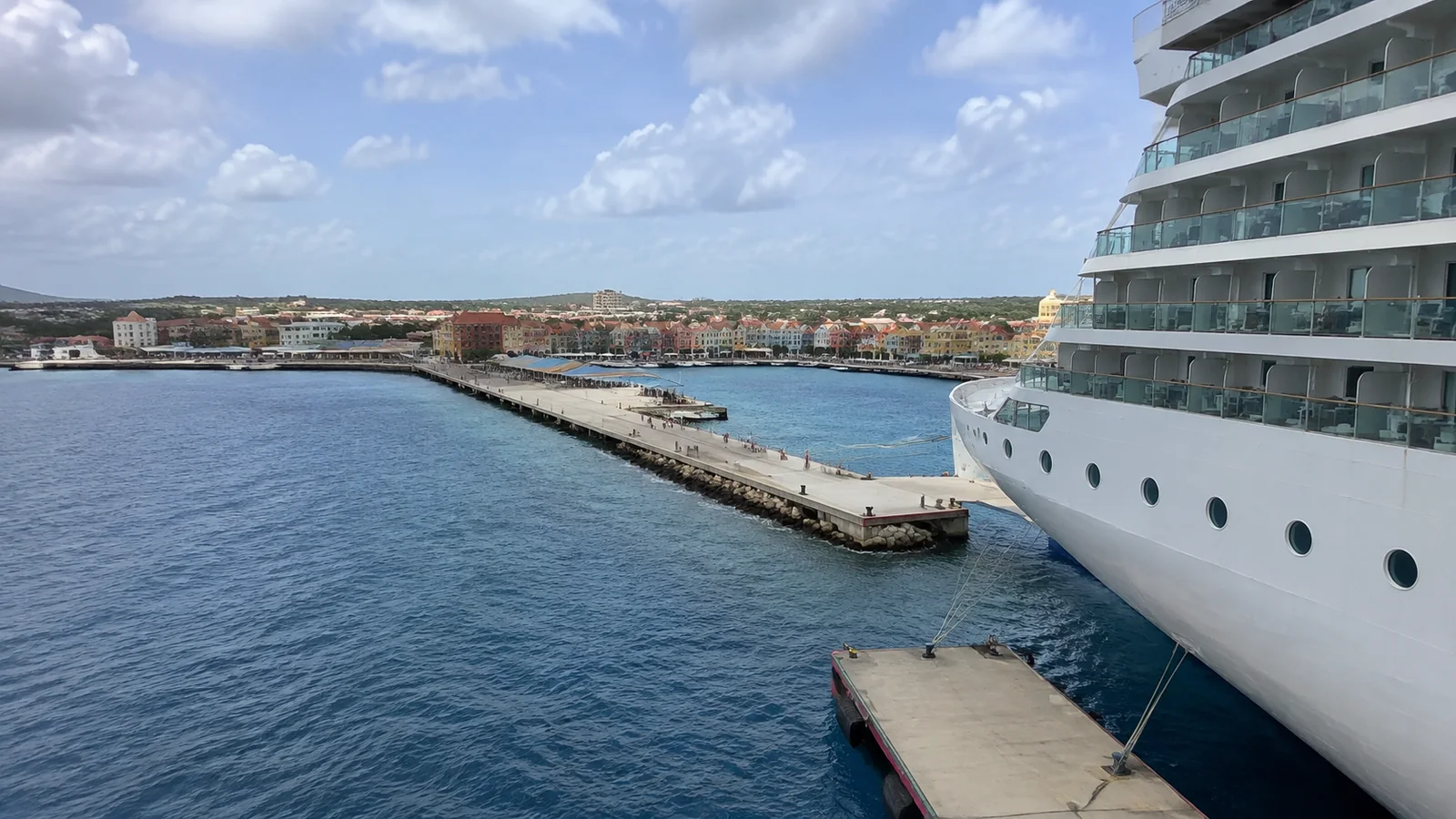 Cruise ship docked beside a colorful waterfront
