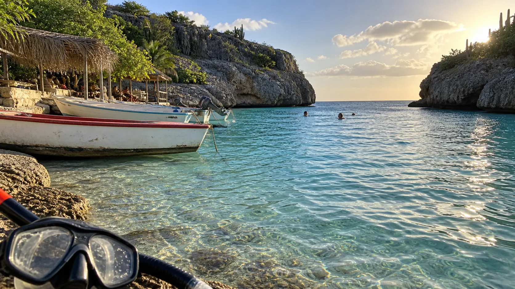 Fishing boats and snorkelers in the clear sheltered cove at Playa Lagun, Curaçao