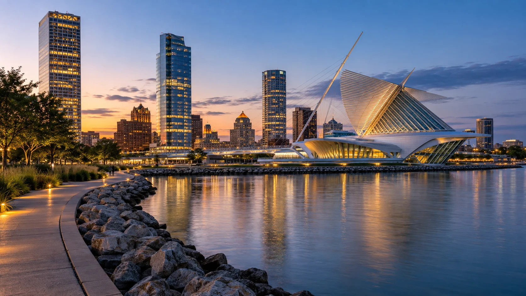 Milwaukee Art Museum and downtown skyline reflected in Lake Michigan at dusk