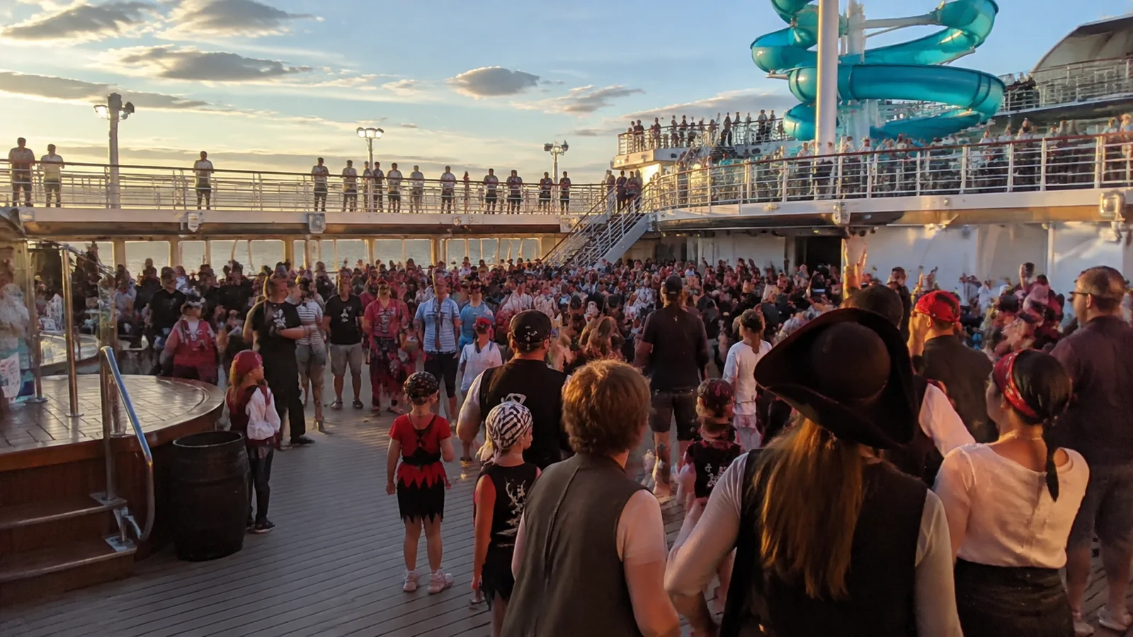 Disney Cruise Pirate Night style deck party with guests gathered outdoors at night.