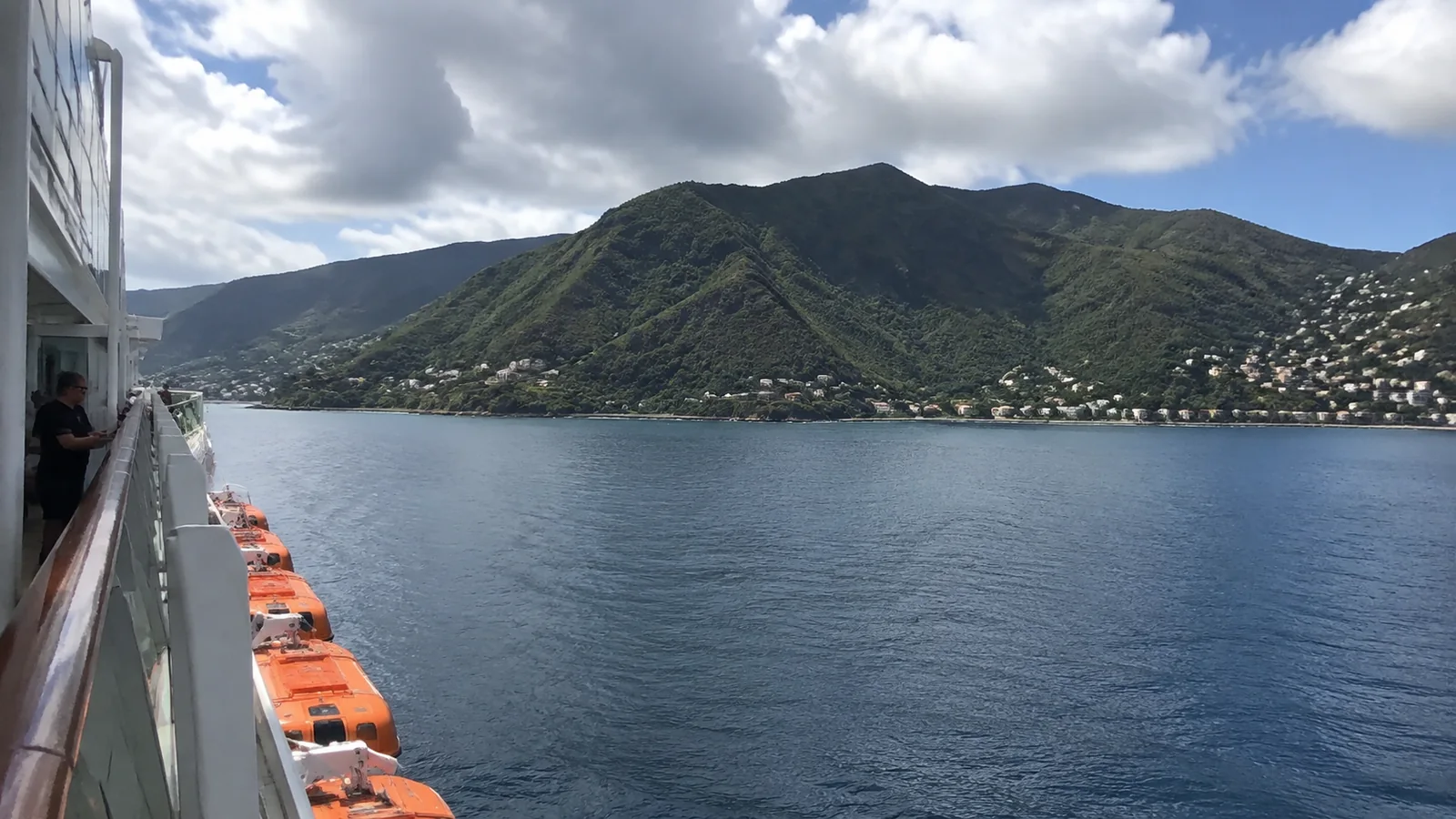 Cruise ship deck overlooking a mountainous coastline