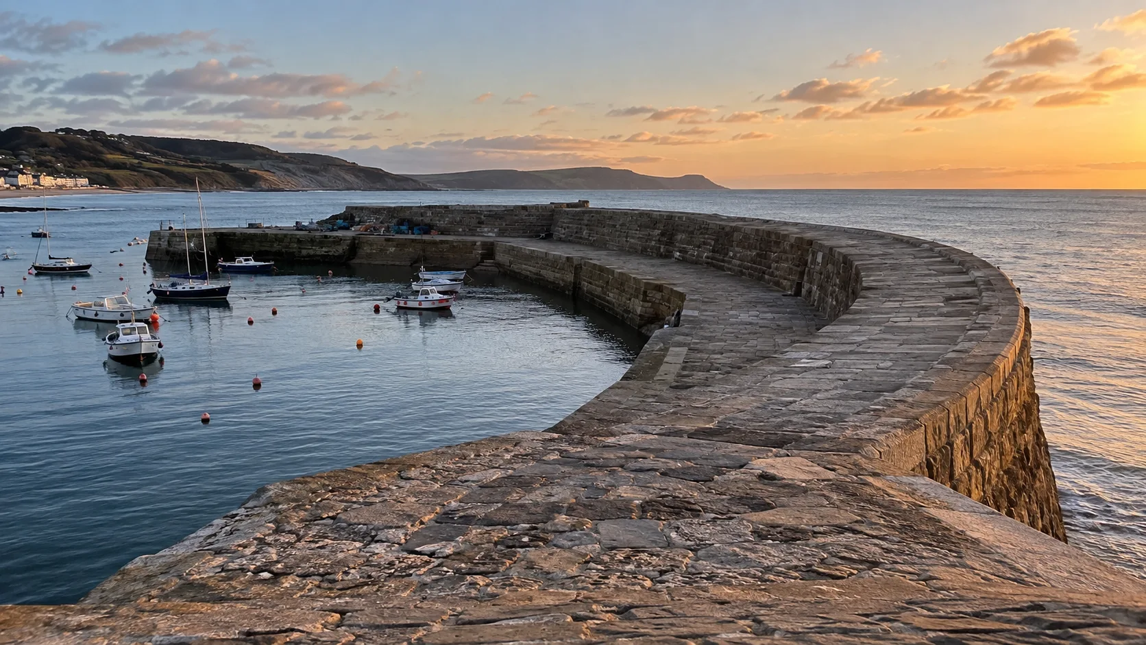Historic stone Cobb curving around the harbor at Lyme Regis.