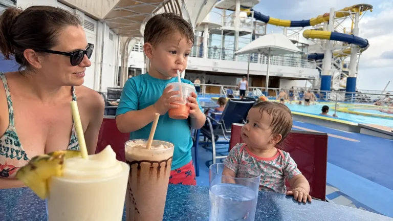 Woman and two young children holding frozen drinks on a cruise ship pool deck