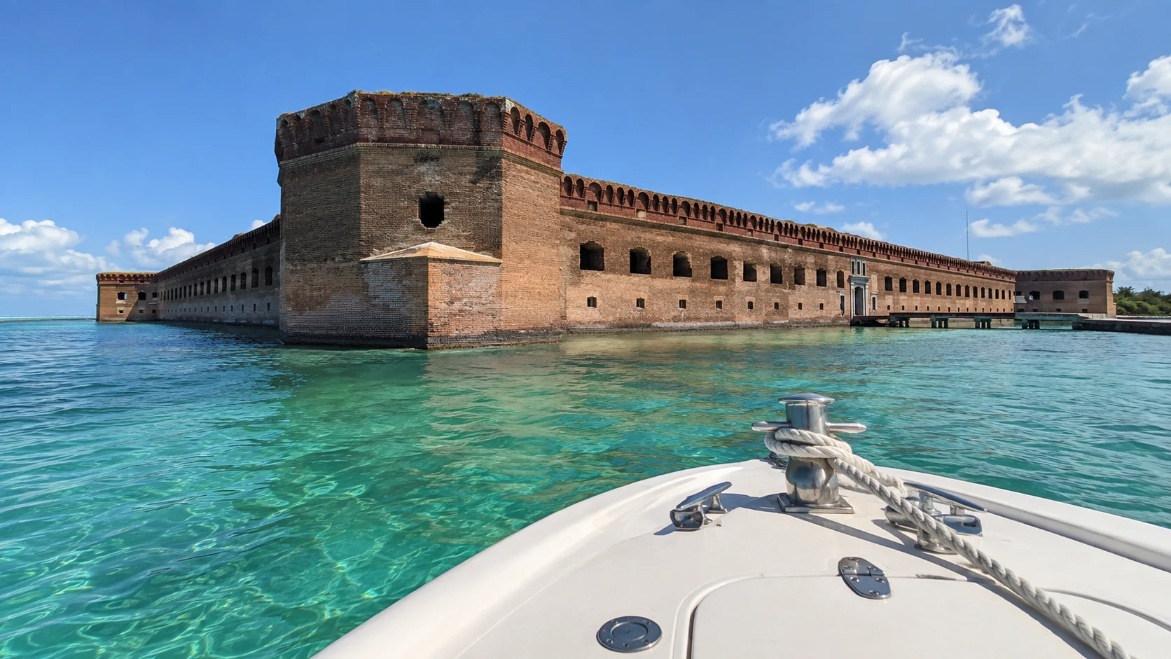 Private boat arriving beside Fort Jefferson in turquoise water