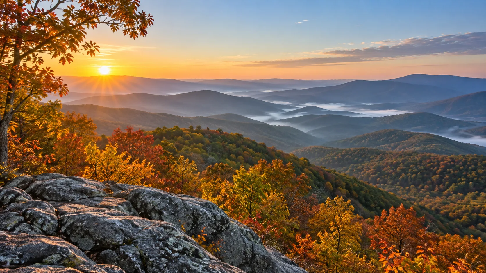 Layered Blue Ridge mountains stretch beyond an overlook in Shenandoah National Park.