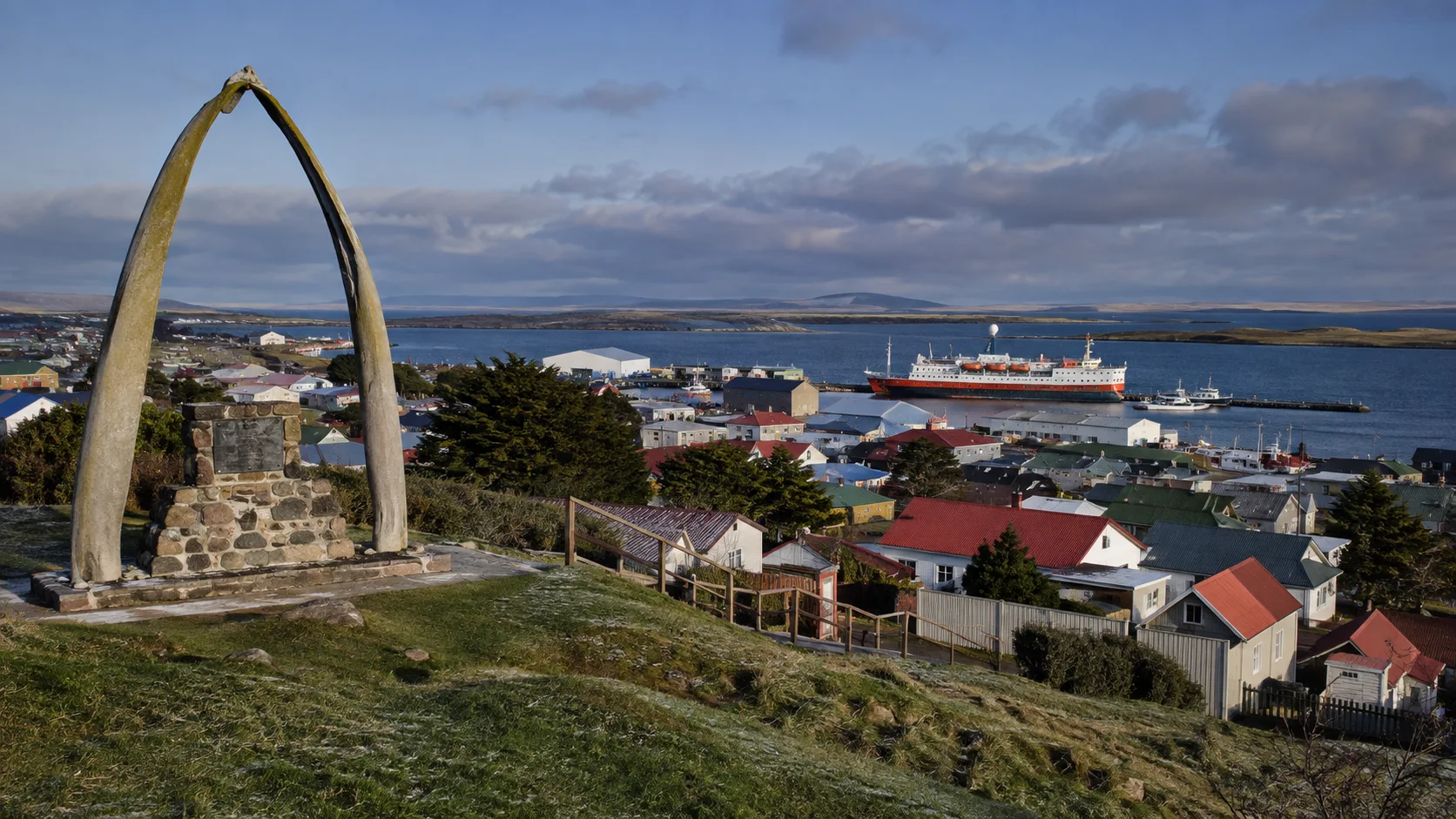 Colorful buildings and monuments along Stanley's waterfront.