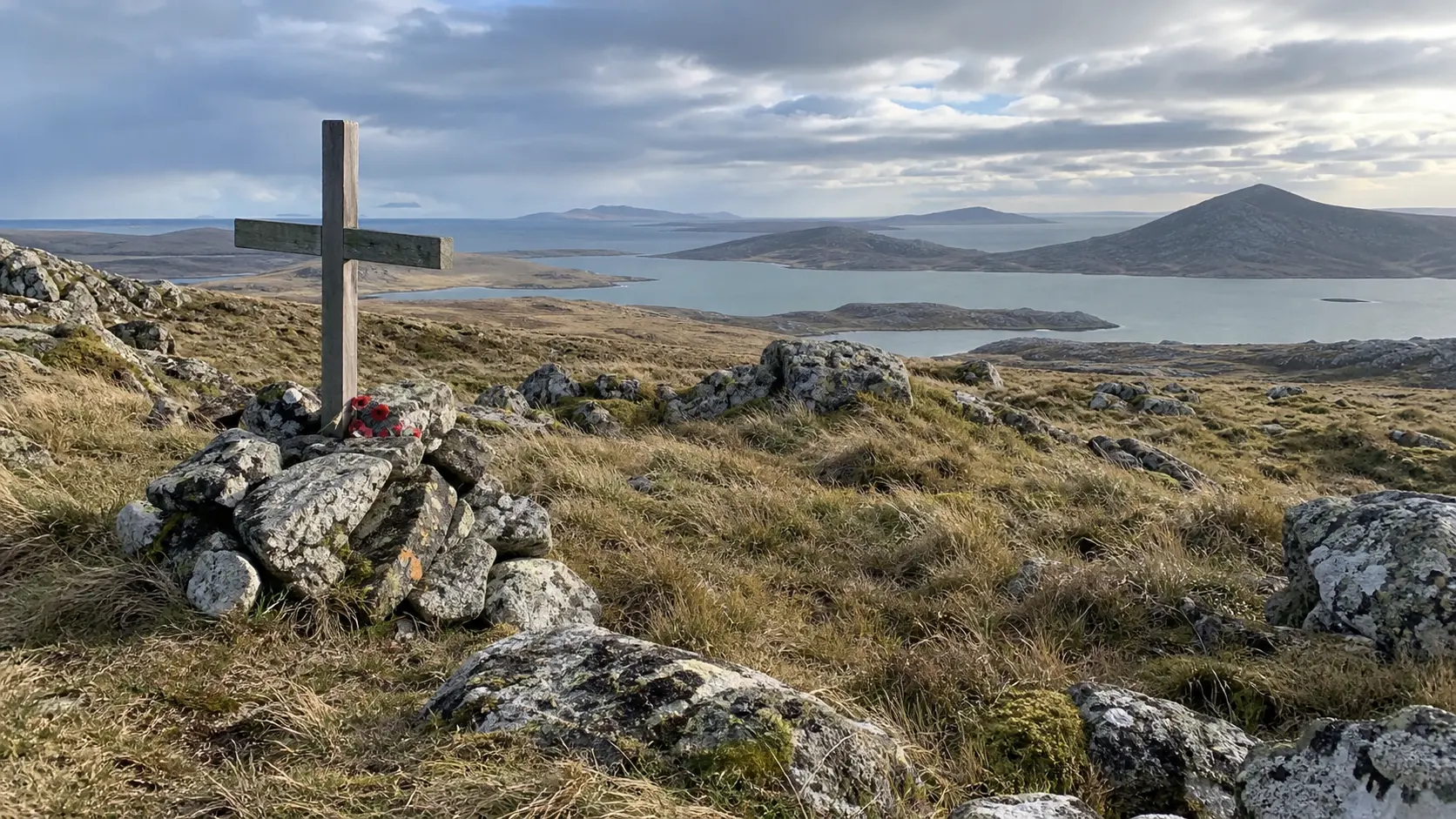 Windswept landscape and memorial at a 1982 Falklands battlefield.