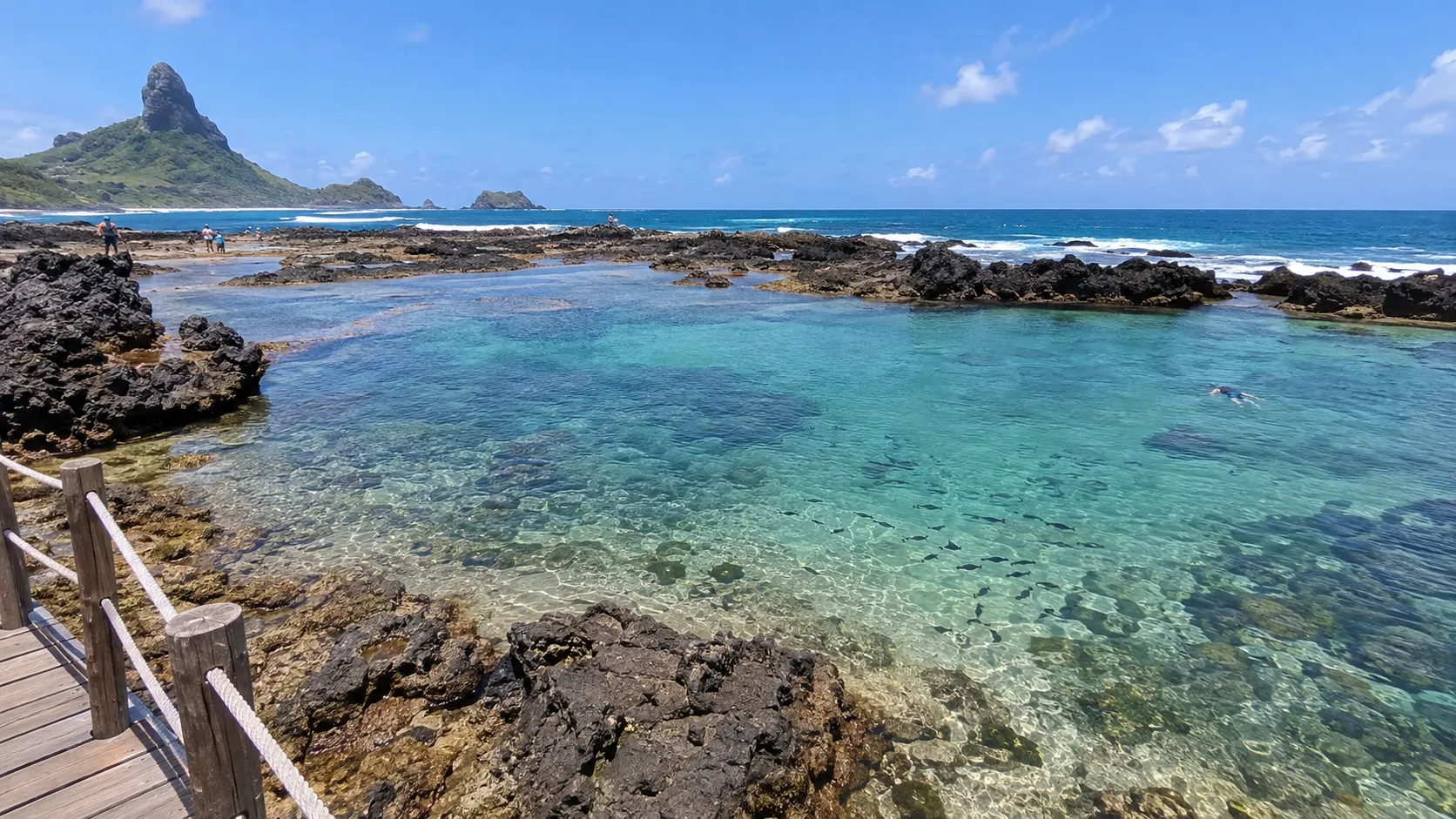 Clear low-tide natural pool and volcanic rocks at Atalaia