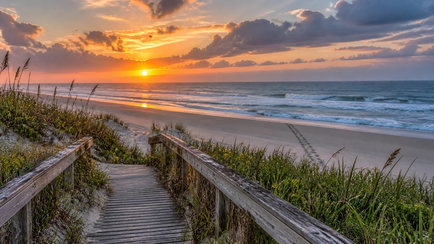 A weathered boardwalk leads to the wild shoreline of Canaveral National Seashore.