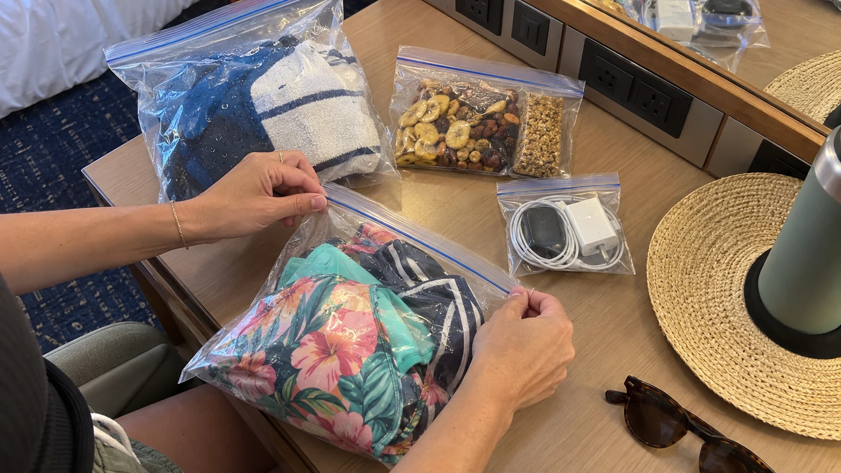 Resealable bags organizing damp swimwear, snacks, and charging accessories
