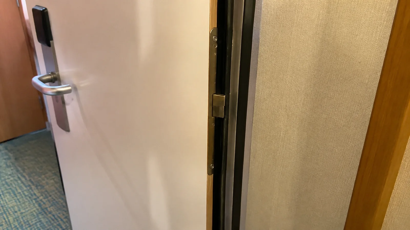 Partially open connecting door inside a cruise cabin