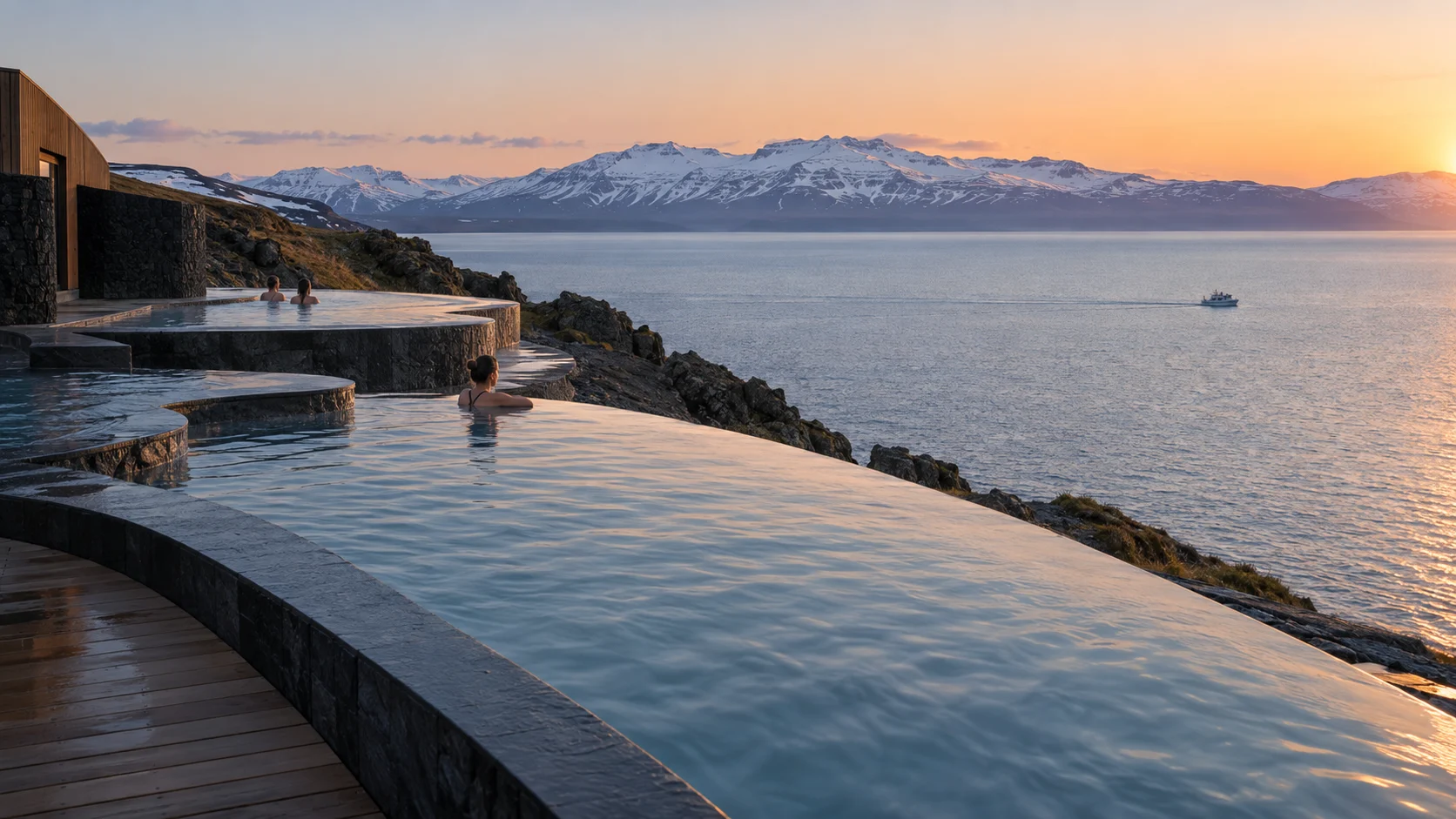 GeoSea infinity pools overlooking Skjálfandi Bay and snowy mountains