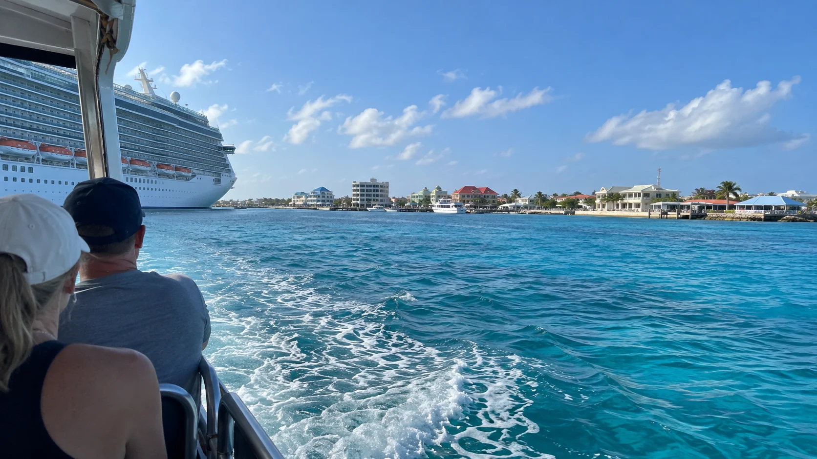 Passenger tender crossing Grand Cayman’s blue harbor toward George Town.