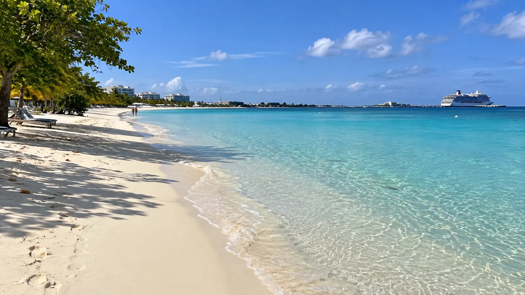 Pale sand and clear turquoise water along Seven Mile Beach.