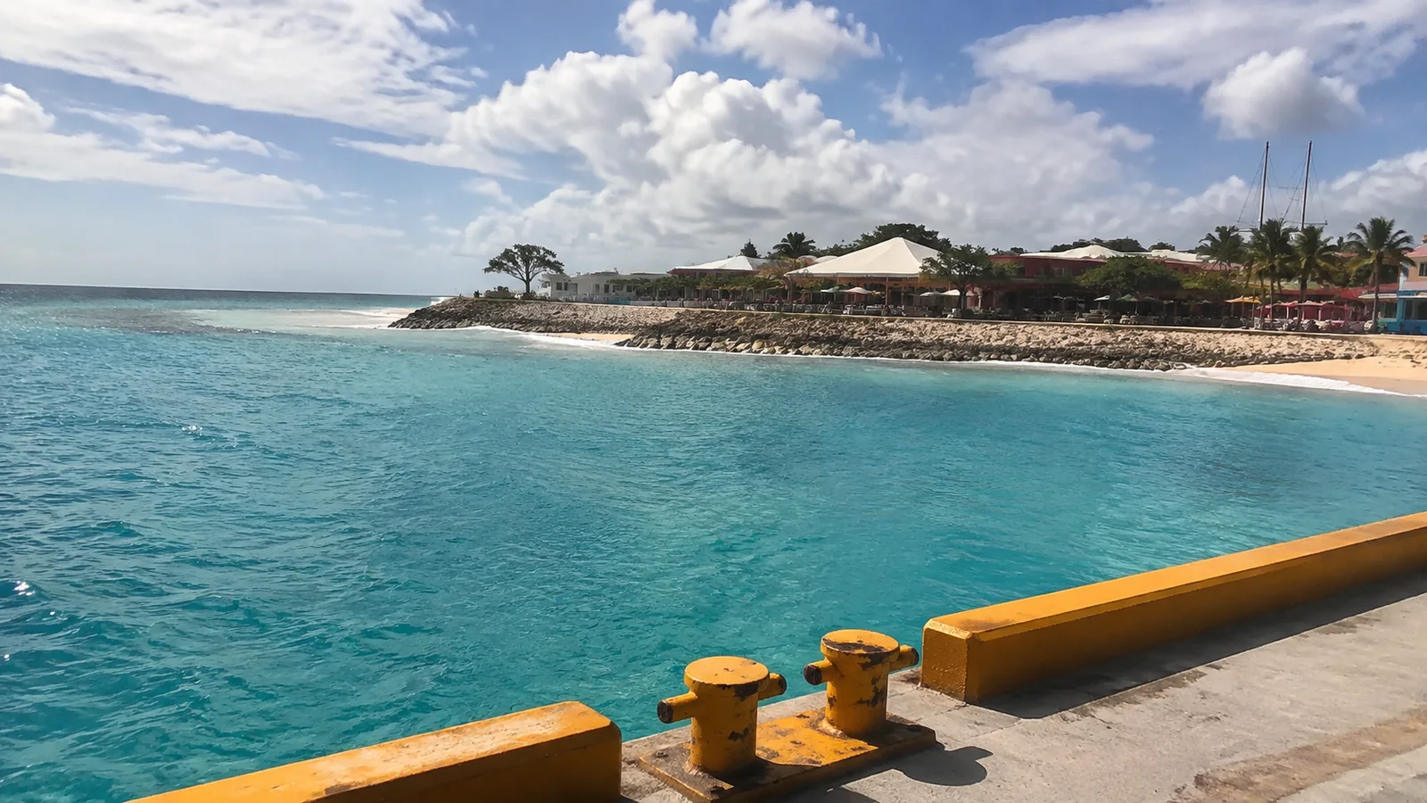 Turquoise shoreline and port viewed from a pier