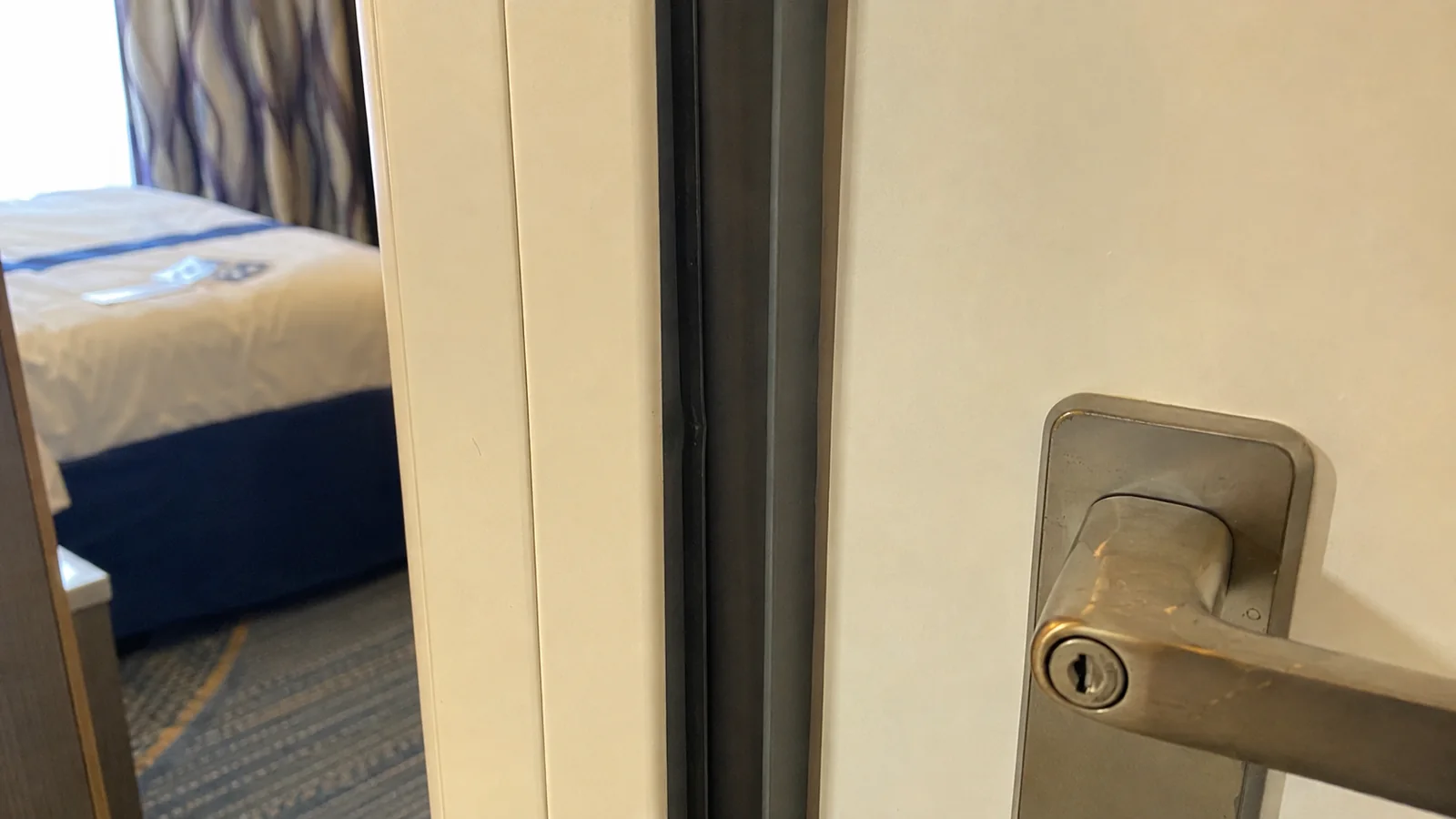 Close-up of the handle and lock on a connecting cabin door.