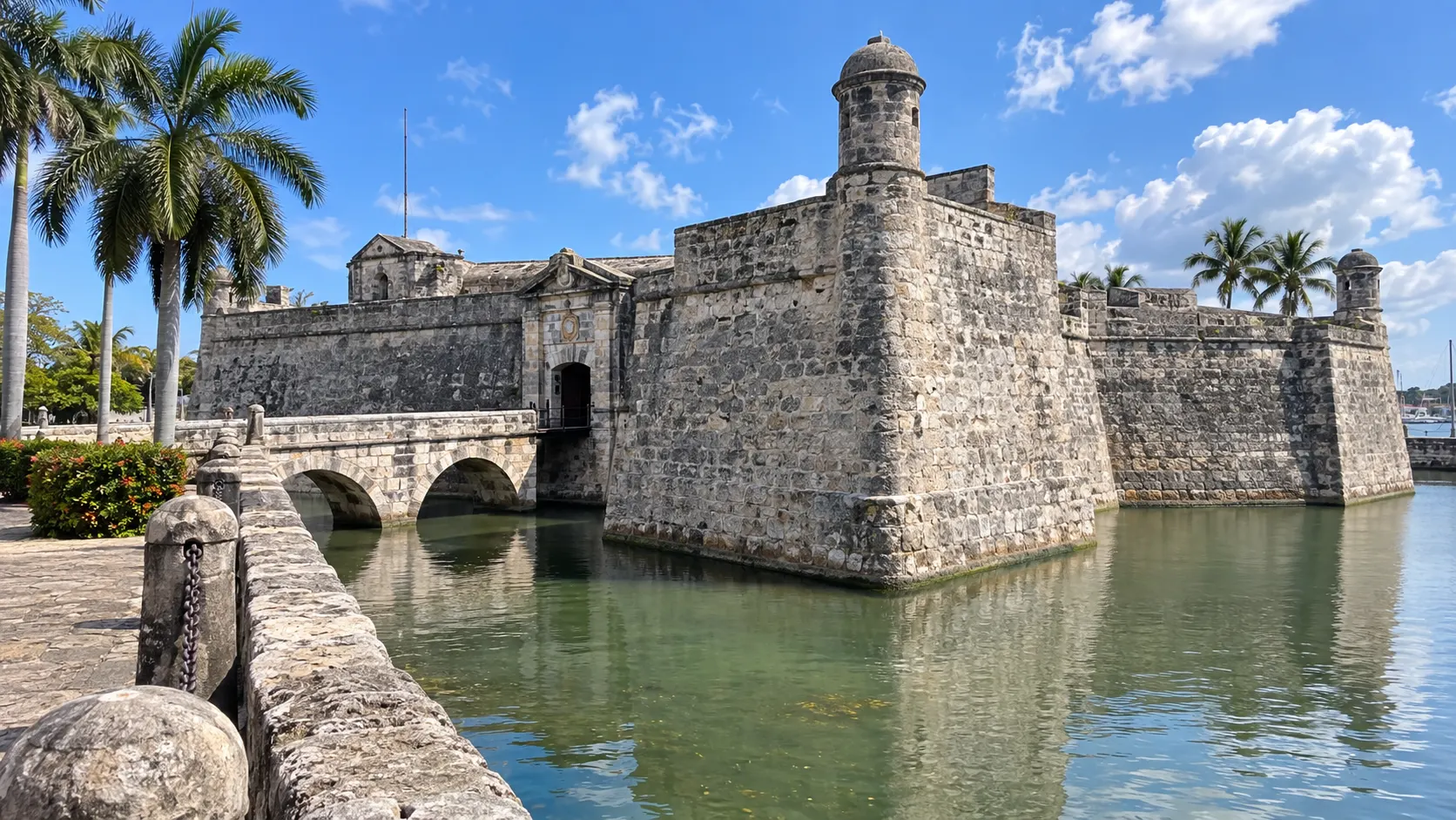 Stone walls, moat and palms at Castillo de la Real Fuerza.