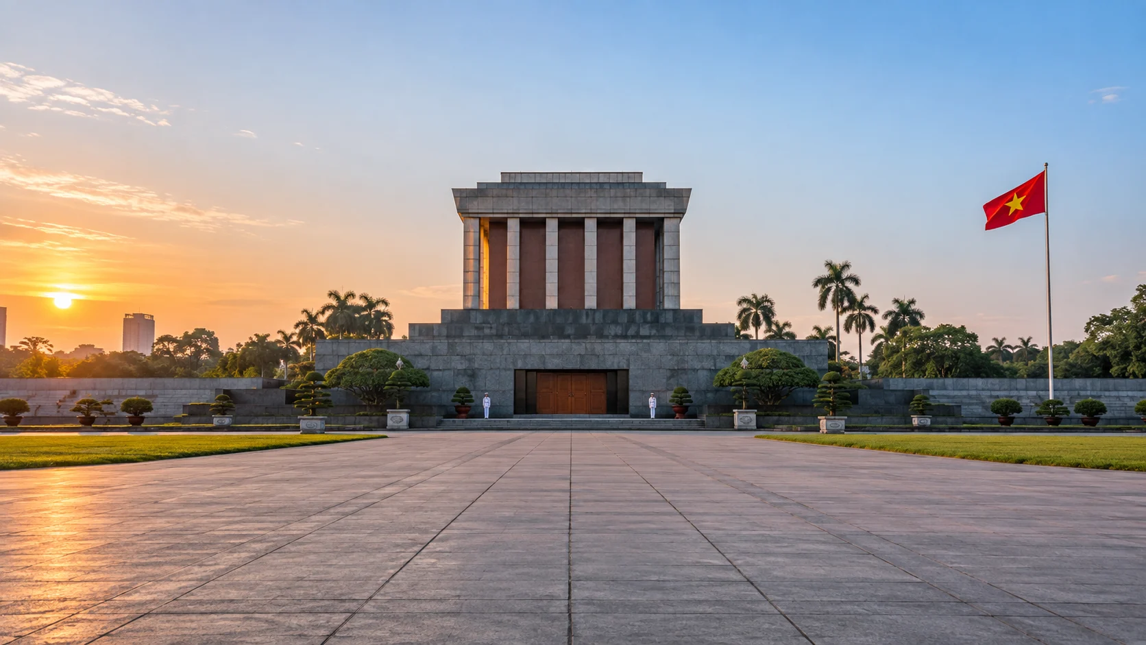 Ho Chi Minh Mausoleum facing the broad stone expanse of Ba Dinh Square at sunrise in Hanoi.