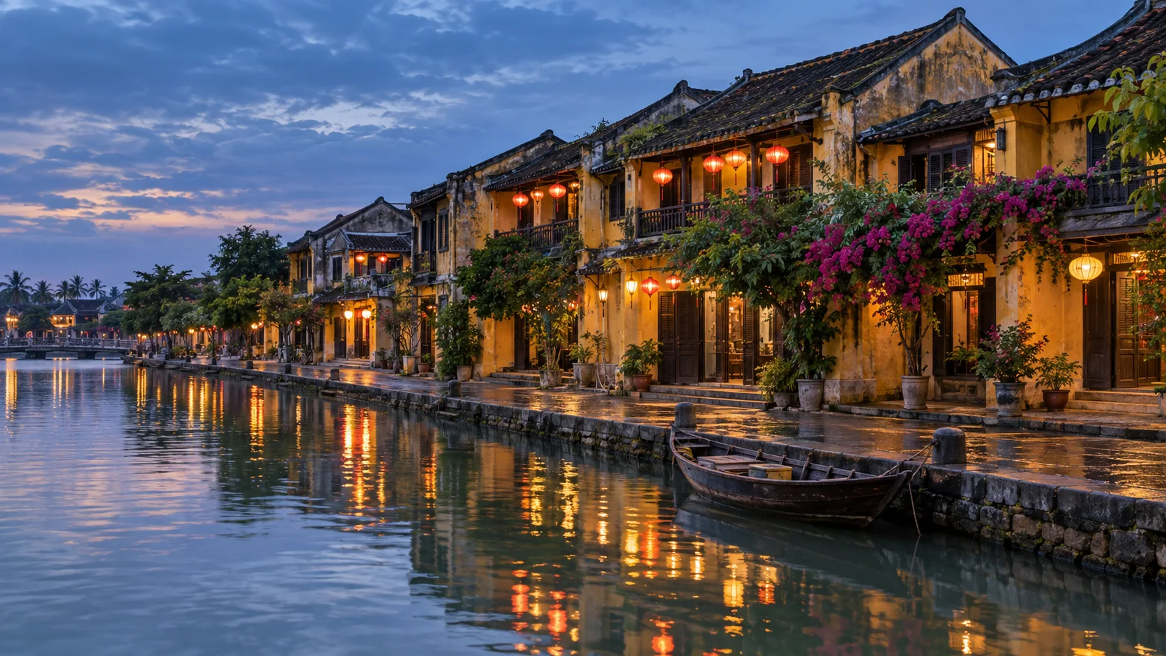 Lantern-lit yellow merchant houses reflecting in the river at Hoi An Ancient Town after rain.