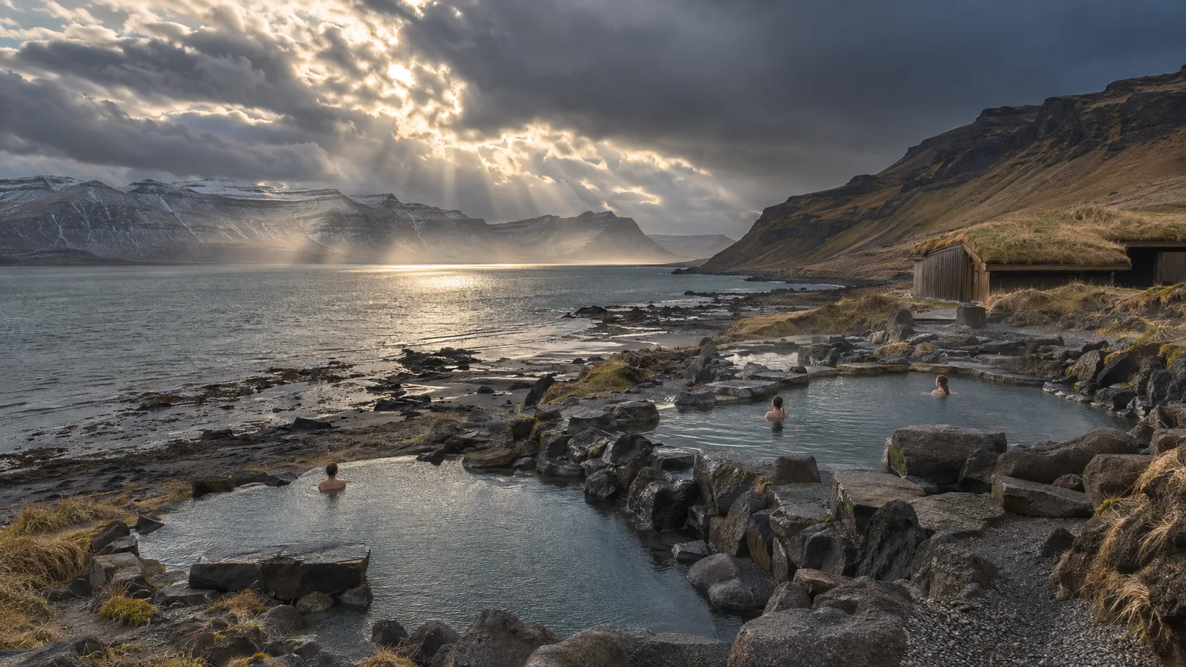 Stone pools descending to the tidal fjord at Hvammsvík Hot Springs