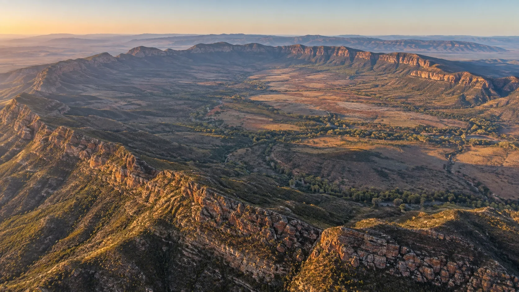 The ring of ridges around Ikara catches dawn light in South Australia's Flinders Ranges.