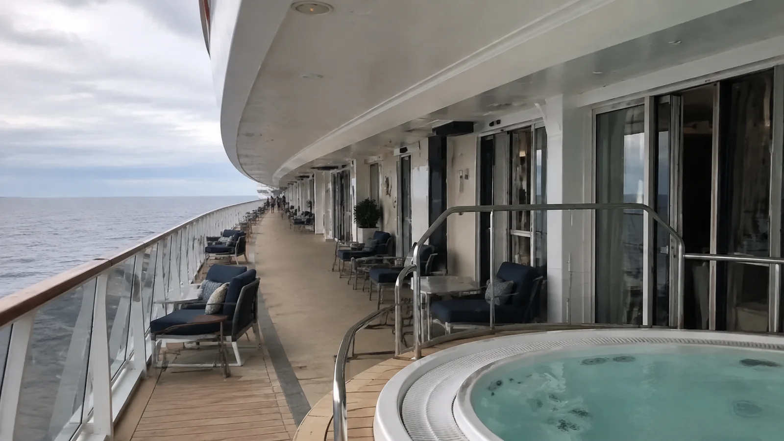 Outdoor hot tub and loungers immediately beside cabin doors.