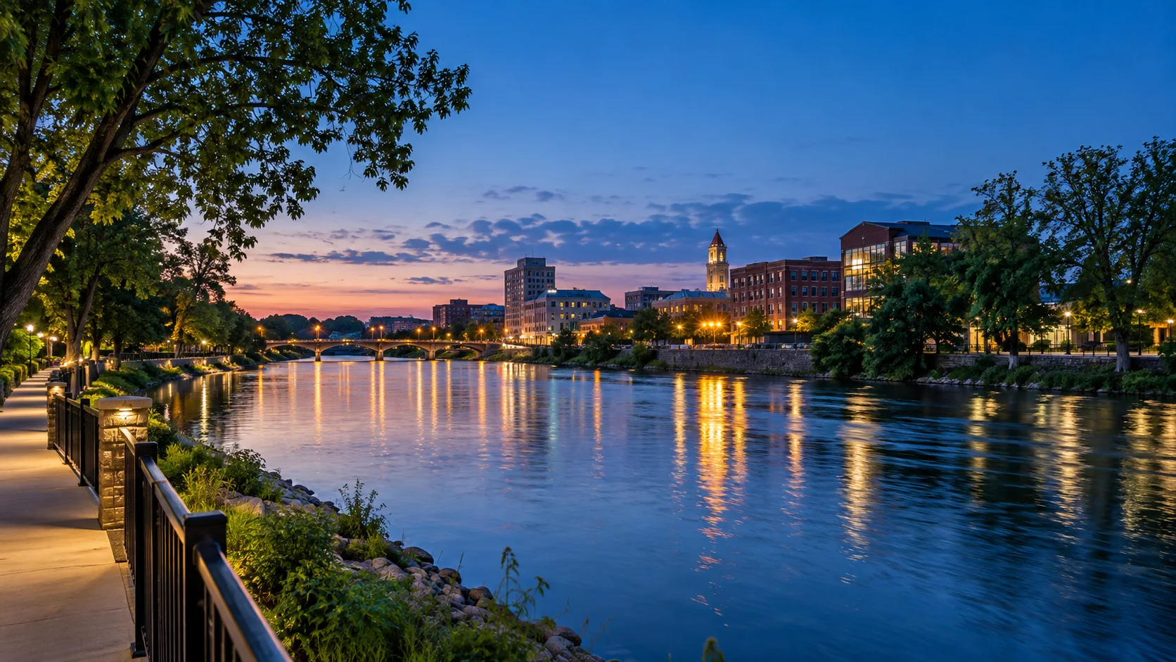 Downtown Janesville reflected in the Rock River during blue hour.