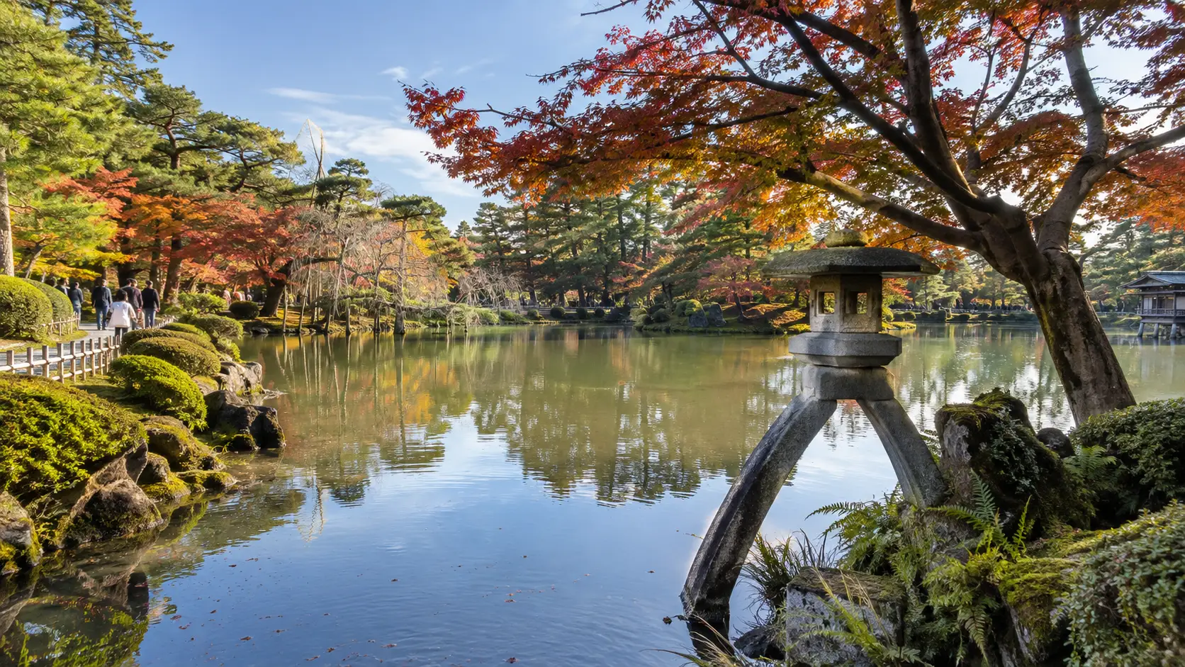 Stone lantern and landscaped pond in Kanazawa's Kenrokuen garden.