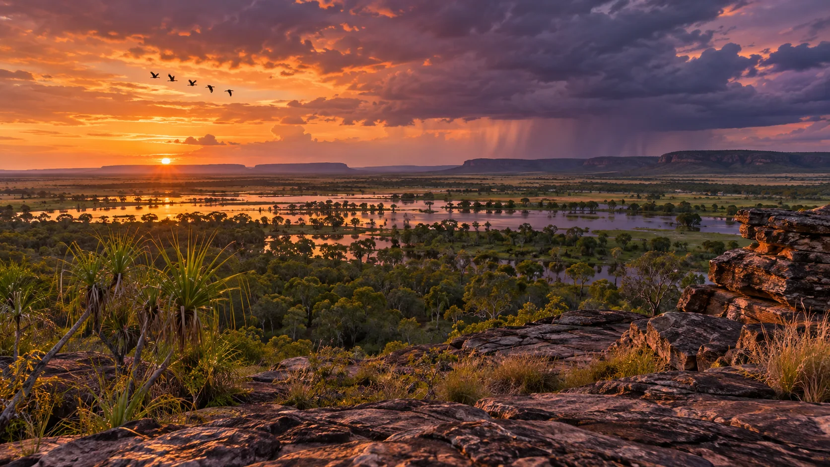 Wetlands glow beneath a stormy sunset from Ubirr in Kakadu National Park, Australia.