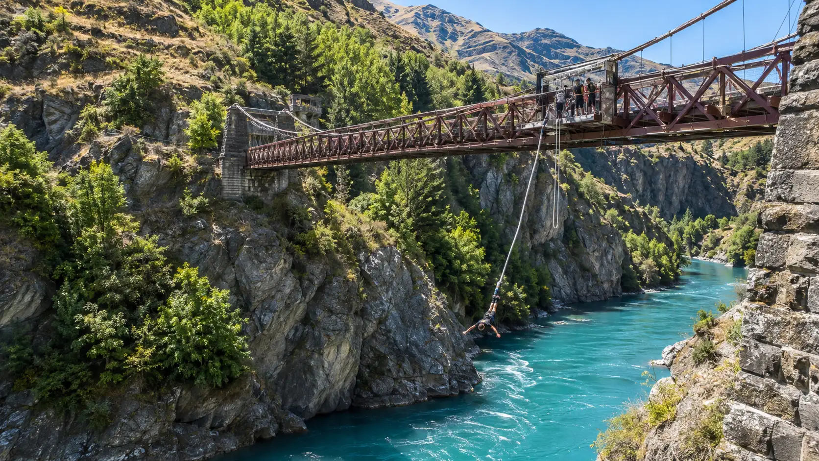 Bungy jumper descending from Kawarau Bridge above the turquoise gorge