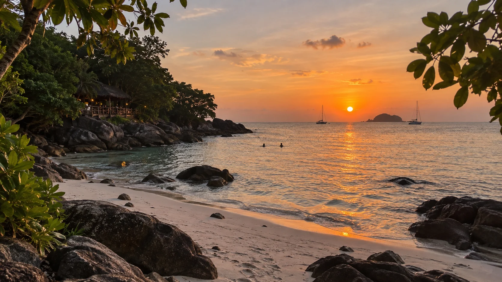 Sunset over the quiet rocky cove at Sunset Beach Koh Lipe