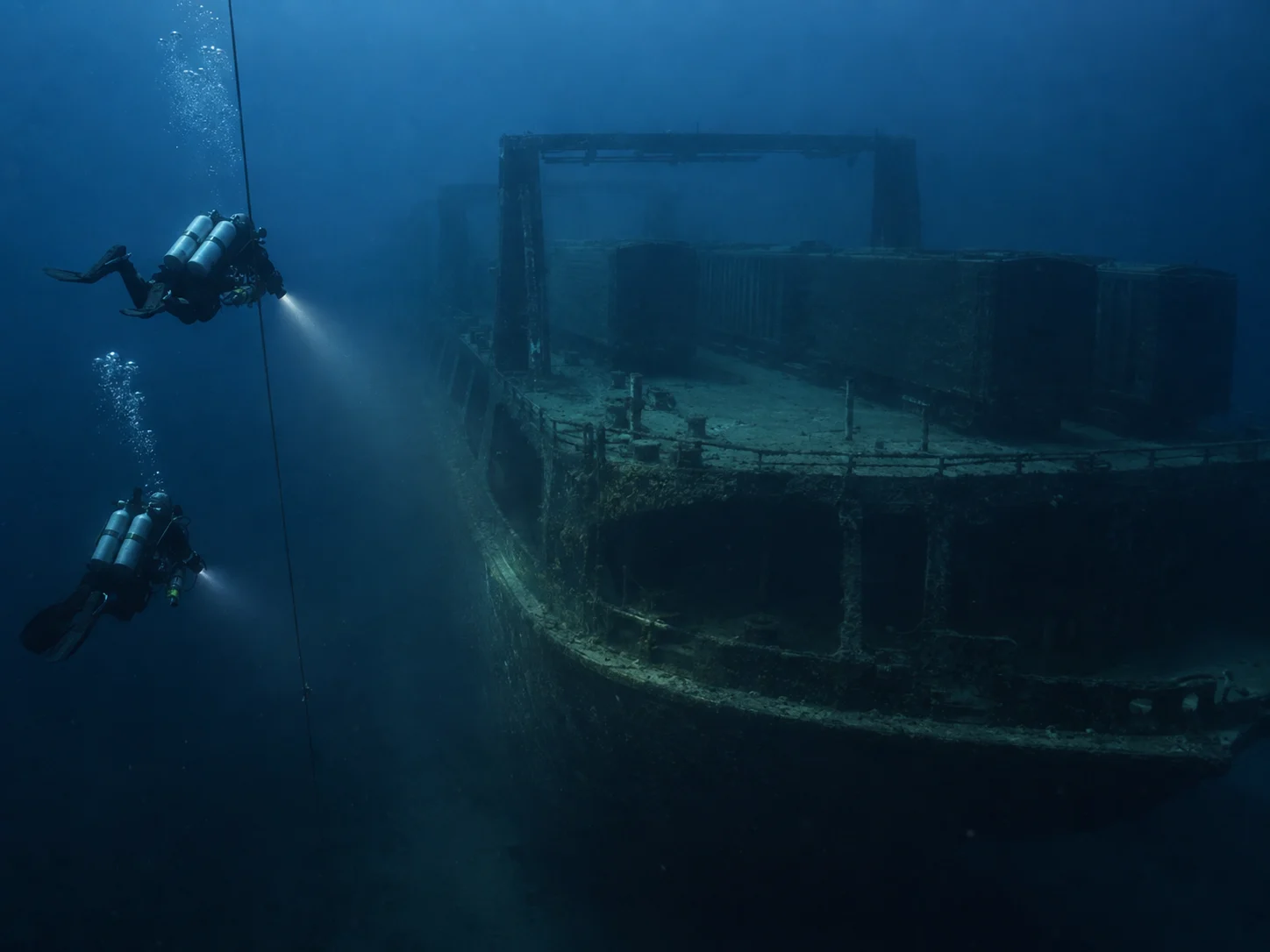 Technical divers approach the deep railroad car ferry SS Milwaukee in Lake Michigan.