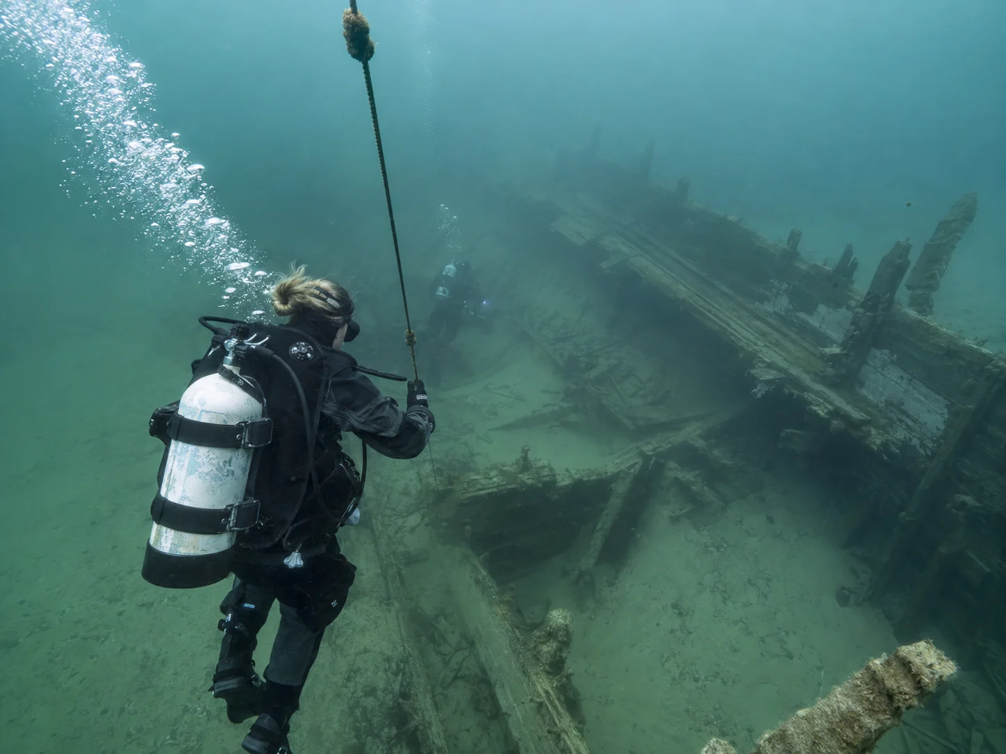 A diver follows a charter line toward the State of Michigan wreck near White Lake.