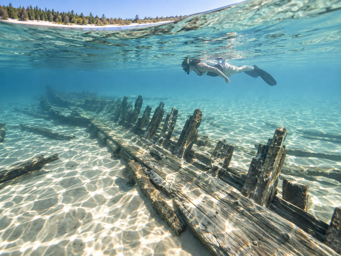 A snorkeler views shallow wooden wreckage of the Three Brothers off South Manitou Island.