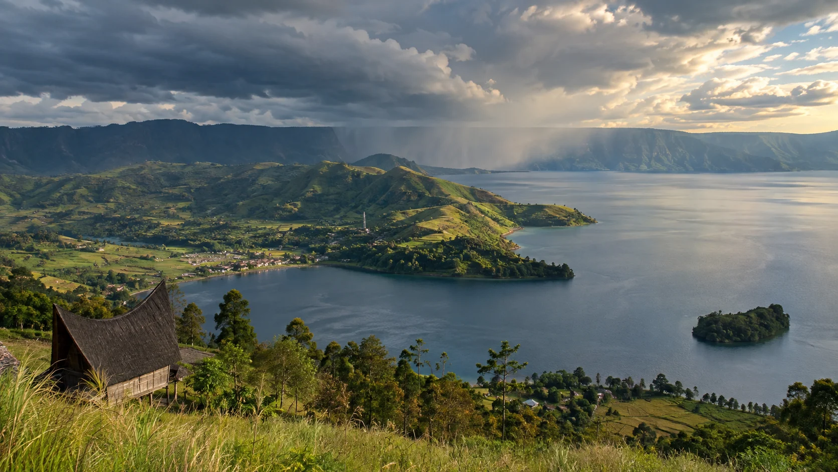Lake Toba surrounds Samosir's green hills beneath a clearing storm in North Sumatra.